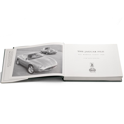 128 - Vintage chrome Jaguar car macot, mounted on a car piston, along with a Jaguar car book, 