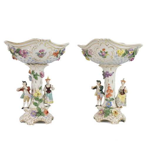 145 - Two late 19th century Dresden pierced comports, each column flanked with figures of a gentleman play... 