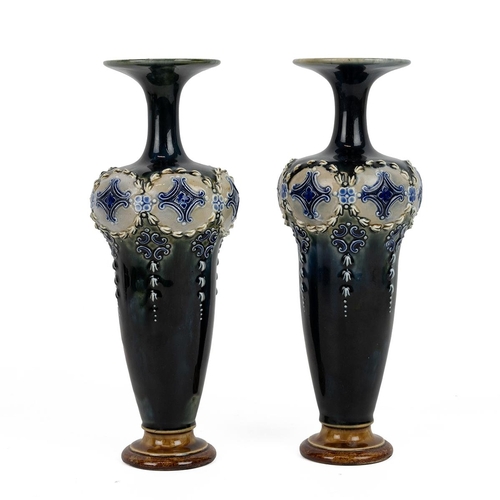 150 - Royal Doulton, circa 1900, a pair of high shouldered vases with slender necks the rims flaring to di... 