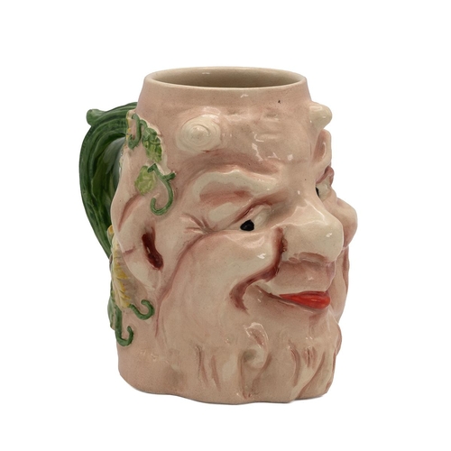 211 - Sarreguemines pottery grotesque face jug, with devil horns and grape vines to the reverse, triangle ... 