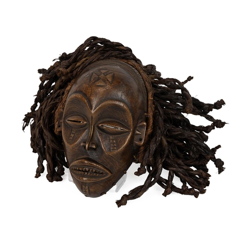 329 - African vintage tribal Chokwe mask. Carved wooden face with platted grass hair. W 30cm, H 26cm.