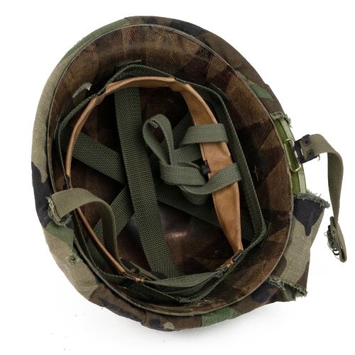 336 - Steinberg Bros American M1 tin helmet, liner and camouflage cover.