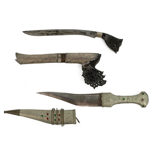 348 - Two middle Eastern daggers, to include a Sumatra dagger with carved and pierced decorated horn handl... 