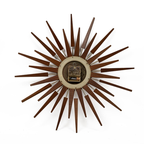 500 - Mid Century 1960s Sun Burst Teak Clock. Quartz movement, maker Anstey & Wilson. Diameter 63cm.