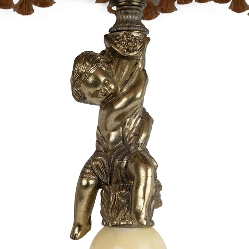 507 - Tall onyx and gilt brass table lamp with a cherub to the column with a bell shaped pink tassled shad... 