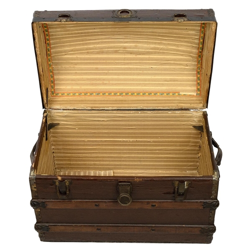 511 - Domed top trunk of lath and canvas construction, with medal bonding and leather carry straps, the la... 