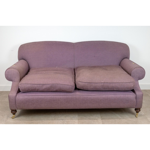 522 - A contemporary 2.5 Seater Sofa upholstered in a lilac corduroy, raised on mahogany bun supports to c... 