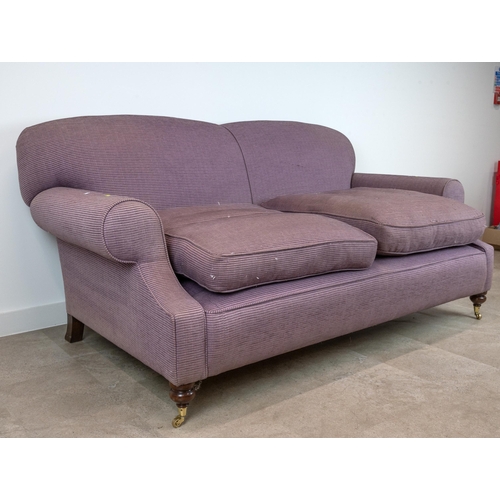 522 - A contemporary 2.5 Seater Sofa upholstered in a lilac corduroy, raised on mahogany bun supports to c... 