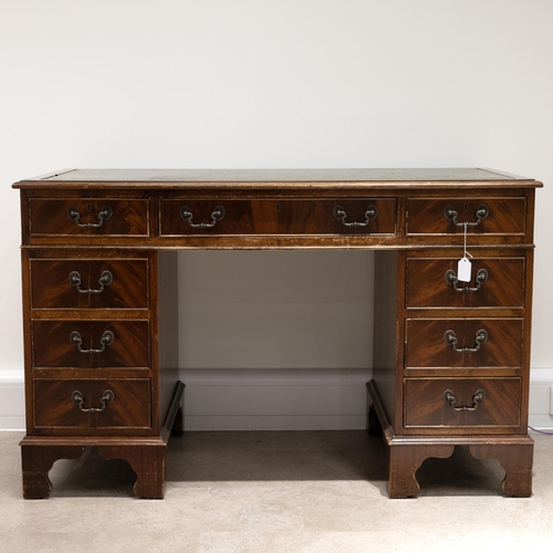 524 - A contemporary tooled leather topped twin pedestal desk with a central drawer flanked by 8 short dra... 