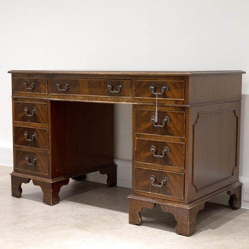 524 - A contemporary tooled leather topped twin pedestal desk with a central drawer flanked by 8 short dra... 