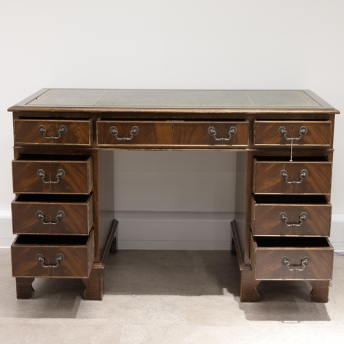 524 - A contemporary tooled leather topped twin pedestal desk with a central drawer flanked by 8 short dra... 