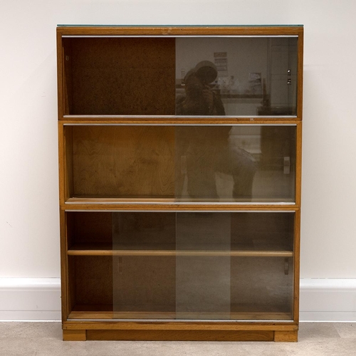 529 - Mid-century three-section teak bookcase, with original label, 117cm high, 89cm long, 24cm deep.