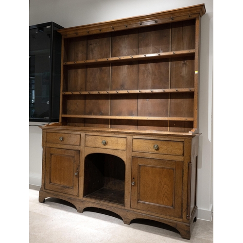 545 - Early 19th century Oak Welsh Dresser, the upper section with pine plank back with shaped cornice abo... 