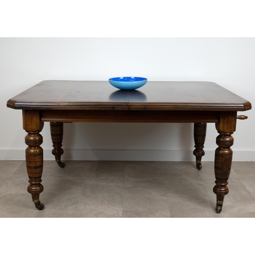 546 - An Edwardian mahogany wind out dining table with chamfered corners and two extra leaves (46.5cm), ra... 