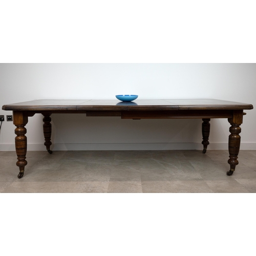 546 - An Edwardian mahogany wind out dining table with chamfered corners and two extra leaves (46.5cm), ra... 