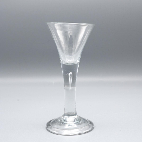 200 - Georgian trumpet shaped wine glass with tear drop in the stem raised on a stepped base H15.5m.