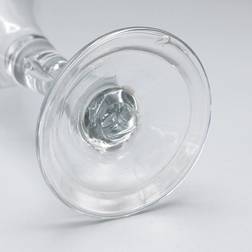 200 - Georgian trumpet shaped wine glass with tear drop in the stem raised on a stepped base H15.5m.