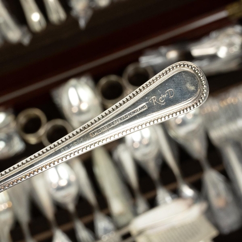 203 - Osborne 8 setting canteen of cutlery (unused) in fitted mahogany tooled leather topped table, raised... 