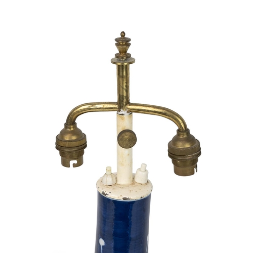 237 - A Chinese blue and white vase, decorated with white flowering plum tree on deep blue ground, on a wo... 