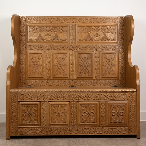 541 - Handmade peg jointed and carved oak settle with tall, profusely relief carved back and scroll shaped... 