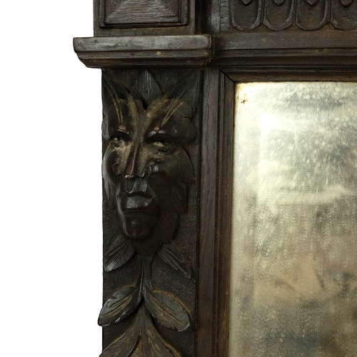 546 - Victorian oak carved Green Man over mantle mirror, the mirror flanked by two columns decorated with ... 