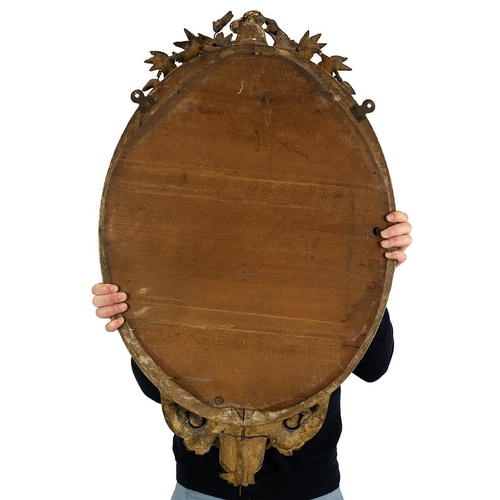 547 - 19th-century gilt framed oval mirror the top adorned with a cherub among wreaths, egg and rose motif... 