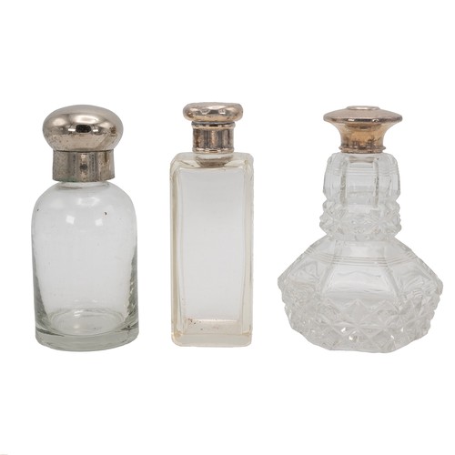 24 - A collection of four silver-topped scent bottles, along with two other plated examples and silver pl... 