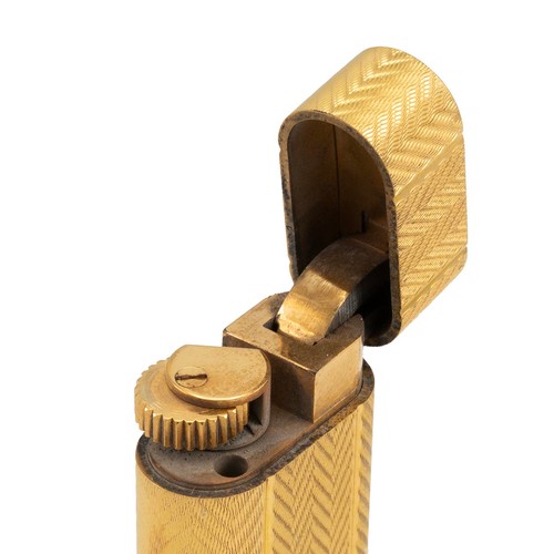 29 - Cartier gold plated engine turned pocket lighter, No 63994 A, in original fitted box.