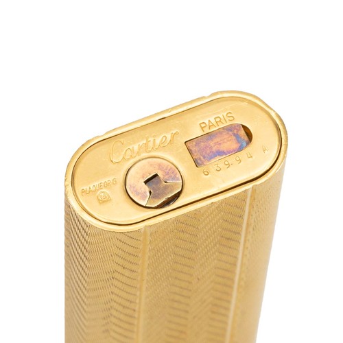 29 - Cartier gold plated engine turned pocket lighter, No 63994 A, in original fitted box.