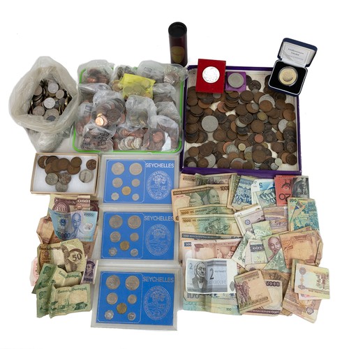 35 - A large collection of world coins and banknotes, including some silver examples.