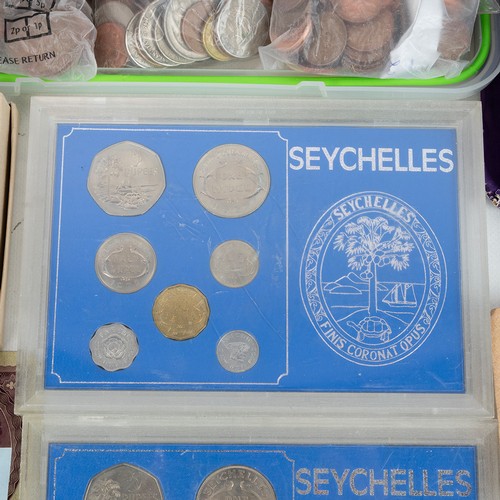 35 - A large collection of world coins and banknotes, including some silver examples.