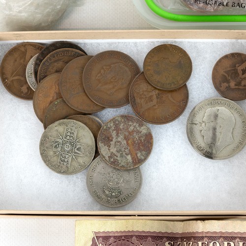 35 - A large collection of world coins and banknotes, including some silver examples.