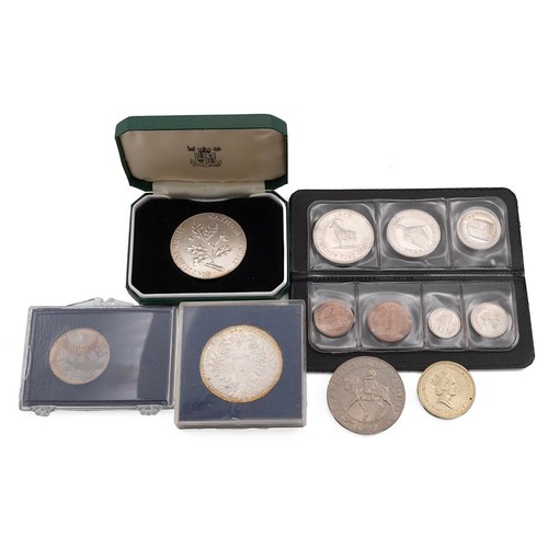 38 - A collection of mixed coins to include Maria Theresa Thaler, National Trust coins, Rhodesian notes a... 