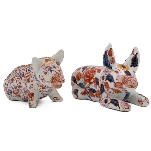 110 - Two Imari Japanese pigs, one seated early 20th Century and a recumbent 19th Century style, both with... 