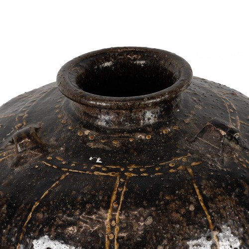 111 - A large Southeast Asian martaban jar with a collar rim, shouldered form with three applied loop hand... 