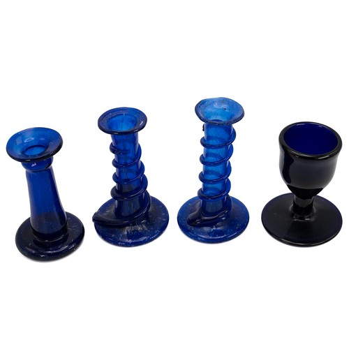 125 - Blue glass to include a small goblet with snapped pontil, the base broader than the cup (H 11cm), to... 