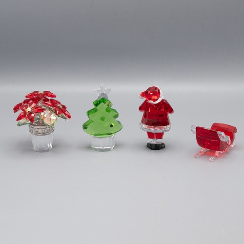 127 - A collection of Swarovski crystal to include a Christmas poinsettia, Father Christmas, Christmas tre... 