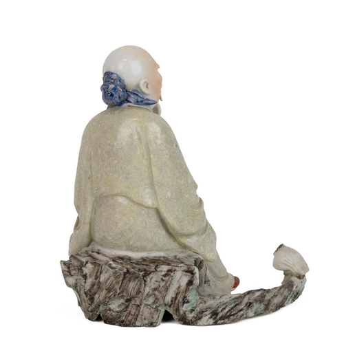 206 - A Chinese porcelain finely detailed figurine of an old man sitting on a tree stump by a duck (the he... 