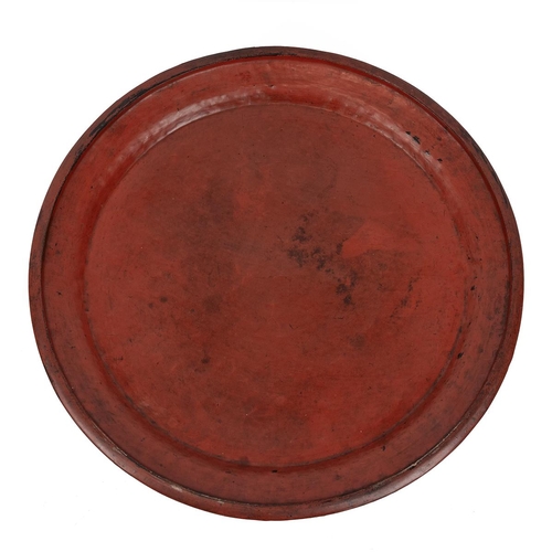 208 - Burmese red lacquered tray table with circular top, raised on a spindle body to a stepped circular b... 