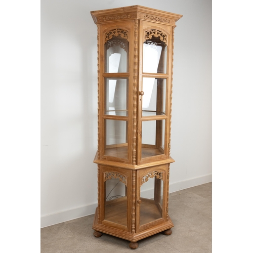 214 - Thai carved teak hexagonal two tier display cabinet with lighting. The top tier with two glass shelv... 