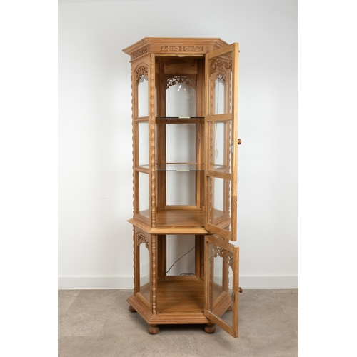 214 - Thai carved teak hexagonal two tier display cabinet with lighting. The top tier with two glass shelv... 