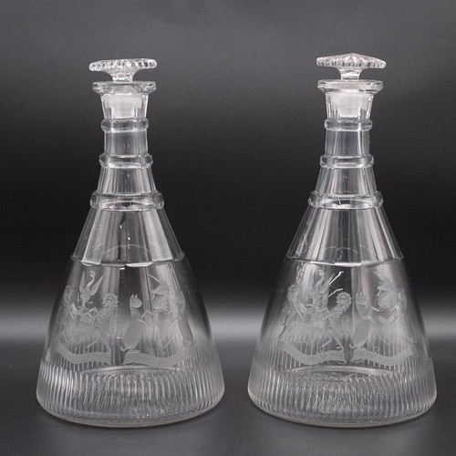 233 - A near pair of late Georgian style magnum cut glass ship's decanters each with three neck rings, mus... 