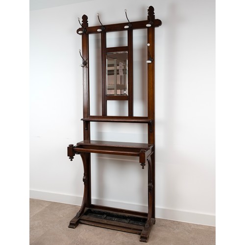 446 - 20th Century mahogany hall stand, with a metal drip try, bevelled mirror, six hanging hooks each wit... 