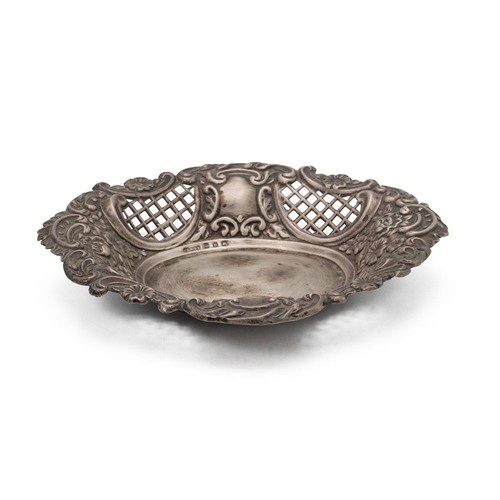 307 - A silver dish with embossed foliate decorations and pierced open panels, weight 60 grams.