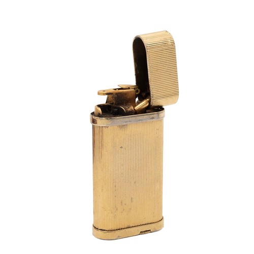 35 - Cartier, a gilt metal lighter, the signed and stamped no 413548, cased and with instructions.