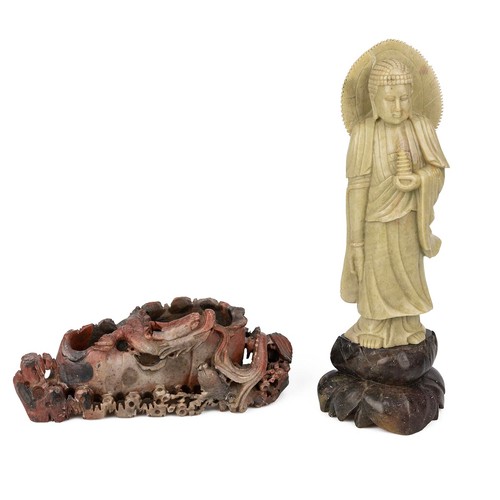 251 - A Chinese-carved soapstone figure of a buddha, 24cm high, along with two other soapstone carvings.