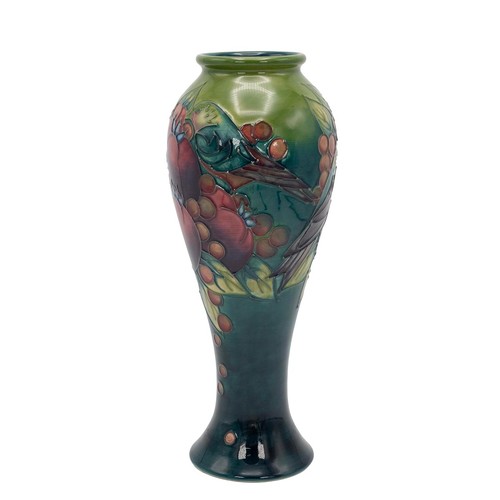 129 - Moorcroft Finches pattern baluster form vase, with slip trailed and hand painted pomegranites, berri... 