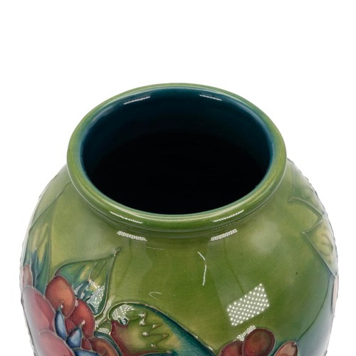 129 - Moorcroft Finches pattern baluster form vase, with slip trailed and hand painted pomegranites, berri... 