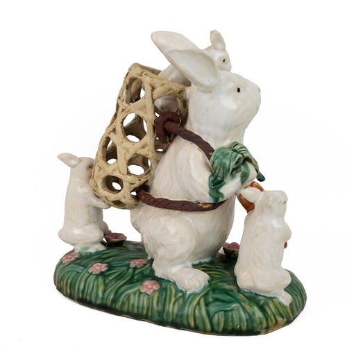 112 - Early 20th century majolica figural group of a rabbit with kits, two at its feet and one in a basket... 