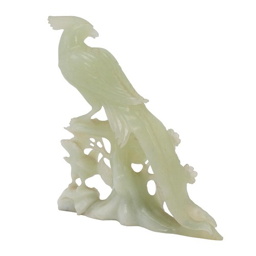 245 - An oriental carved Jade figure of a golden pheasant on berries. H 15cm.